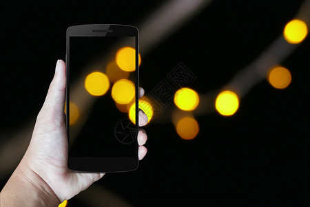 手头的现代移动电话商业屏幕棕榈城市之夜触摸屏背景电讯讲话绿色技术背景图片