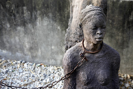 桑给巴尔石头城非洲奴隶贩卖雕像纪念碑种族旅行纪念馆地点石材石头背景