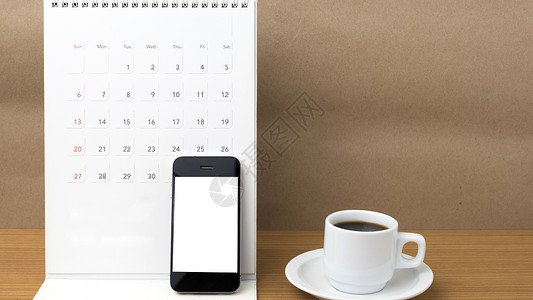 咖啡杯 电话和日历商业咖啡白色铅笔职场杯子笔记工作写作桌子背景图片