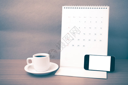 咖啡杯 电话和日历办公室职场桌子写作商业白色笔记本铅笔咖啡杯子背景图片