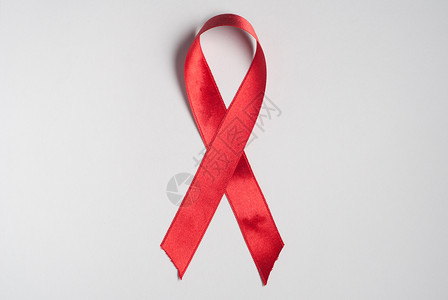 艾滋病宣传  红丝医疗机构白色疾病意识警觉剪裁红色丝绸勋章背景图片