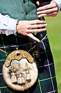 苏格兰氏族苏格兰风笛短裙格子男人衬衫传统音乐家国家孢子管道乐队背景