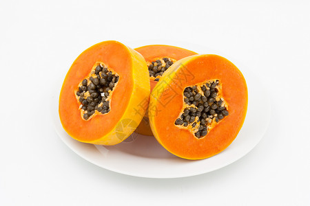 盘子里的红木瓜种子营养木瓜黄色热带橙子甜点白色食物水果背景图片