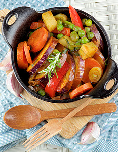 颜色多彩的蔬菜炖锅土豆橙子韭葱晚餐萝卜茄子青菜美食家餐巾背景图片