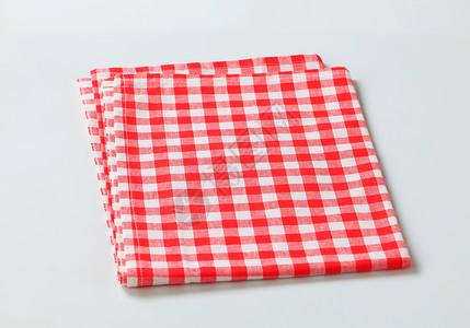 红色和白白桌单餐巾白色折叠桌布检查茶巾餐巾纸抹布织物背景图片