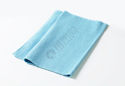 蓝棉地垫折叠餐垫餐巾蓝色编织餐巾纸库存台垫棉布织物背景图片