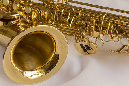 金色白色金色萨克斯管奢华白色波浪状褶皱织物艺术音乐材料黄铜喉舌背景