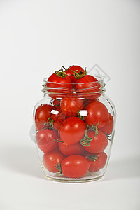 樱桃西红柿在玻璃罐子上加白红色养护白色蔬菜烹饪食物高清图片