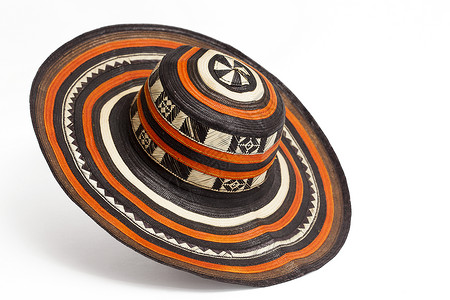 玻利瓦尔来自哥伦比亚的传统帽子 叫做苏布雷罗Vueltiao橙子褐色黑色符号针织文化龙蒿甘蔗工艺品字符串背景