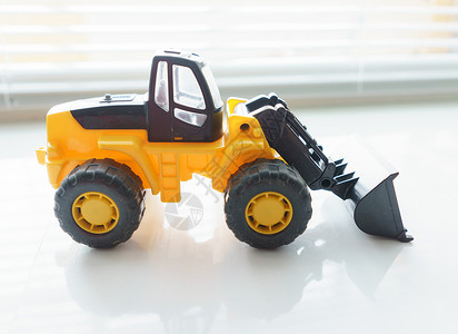 推土机玩具特写玩具轮装入器地球挖掘机推土机搬运工机械卡车前端机器运输倾倒背景