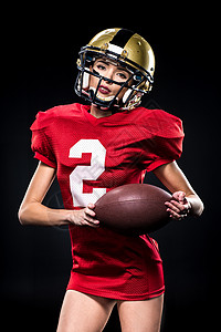戴头盔的女性足球运动员教练活动橄榄球操场力量运动玩家活力冒充女士背景图片