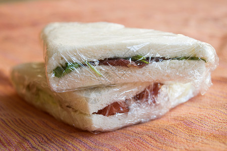 以透明胶卷包裹的三明治电影面包白色小吃火腿挫败胸部背景图片