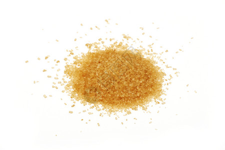 一片棕色甘蔗糖洒在白色上黄色颗粒状美食营养水晶食物背景图片