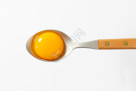 勺子上生蛋黄食物金属高架汤匙背景