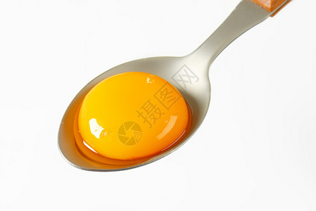 勺子上生蛋黄食物金属汤匙背景