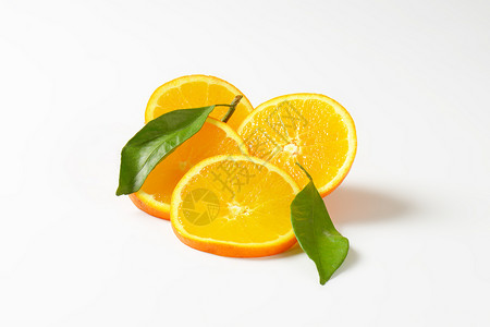 新鲜橙红切片横截面水果树叶食物背景图片