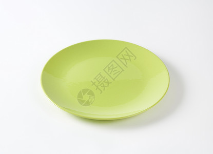 平石灰绿色餐盘纯色餐具夹层板陶器轿跑车板石灰绿圆形背景图片