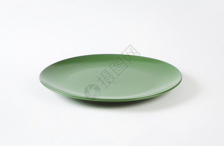 圆圆固绿色晚餐盘陶器制品圆形餐盘沙拉盘餐具陶瓷绿色纯色轿跑车板背景图片