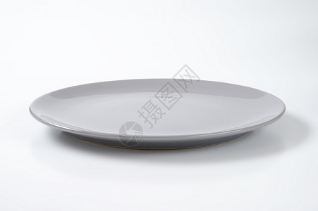灰色晚餐盘圆形纯色餐具轿跑车板陶瓷陶器沙拉盘灰色餐盘制品背景图片