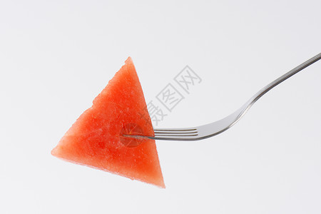 叉子上的西瓜红色食物水果背景图片