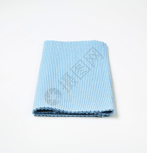 蓝棉地垫棉布编织肋骨蓝色台垫桌布纺织品折叠织物背景图片