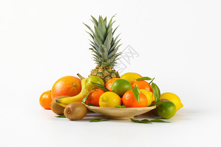热带水果类种菠萝黄色异国香蕉情调团体盘子柠檬绿色奇异果背景图片