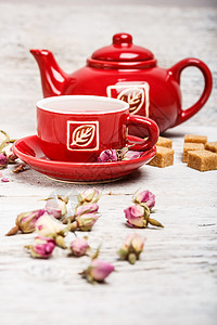 玫瑰芽茶茶壶玫瑰红色桌子飞碟杯子背景