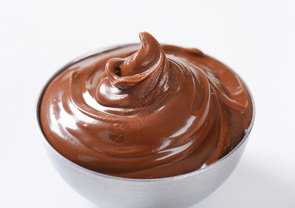 巧克力漩涡黑栗子黄油扩散配料可可甜点食物软糖漩涡金属巧克力坚果小吃背景