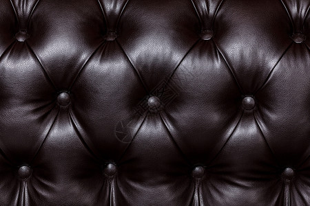 单个棕色沙发黑棕色皮质和纽扣的近镜头 Furnitu背景