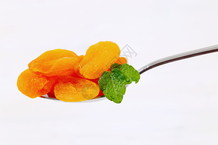 汤匙干杏仁橙子团体食物金属小吃勺子甜点背景图片