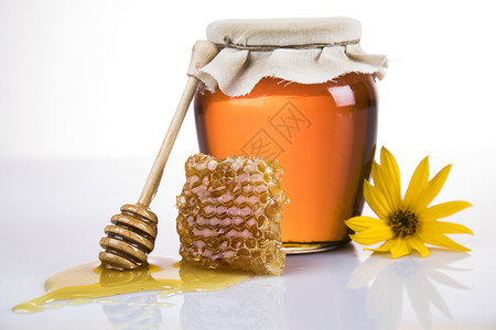 液体蜂蜜罐营养花蜜金子梳子疗效国家玻璃食物糖浆蜂蜜背景图片