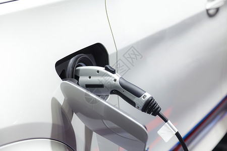 向未来再出发向电动汽车充电 运输的未来驾驶力量电缆杂交种环境车站交通技术充值插头背景