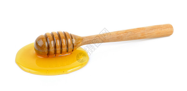 带蜂蜜的木制蜂蜜勺子糖浆液体白色食物黄色背景图片