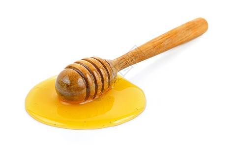 带蜂蜜的木制蜂蜜白色黄色糖浆液体食物勺子背景图片