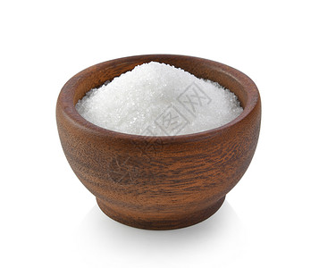 木糖醇白色背景的木碗糖甘蔗糖果宏观木头颗粒状水晶棕色食物营养立方体背景