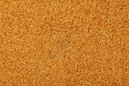 棕色甘蔗 suga 的特写背景黄色颗粒状水晶背景图片