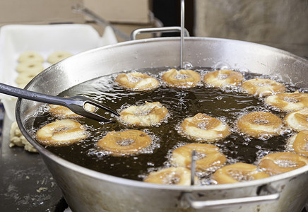 饼家街上的炸甜甜圈美食食物传统早餐小吃糕点冷却甜甜圈油炸蛋糕背景