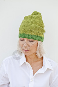 穿着温暖绿色帽子的年轻美女背景图片