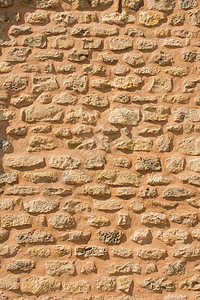 用同种石头砌成的墙砖块地面墙纸岩石红色海滩石墙背景材料建筑学背景图片
