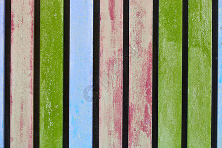 五颜六色的蓝粉色和绿色木制陈旧木板墙背景图片