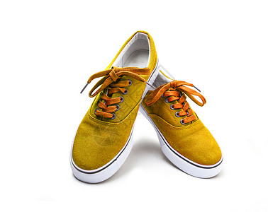 一双黄色的画布鞋 白纸上隔着皮革橡皮白色运动橙子男性材料男孩们靴子男人背景图片