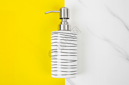 用于液体肥皂或洗发水的陶瓷泵瓶产品瓶子黄色洗澡清洁剂浴室化妆品大理石工具卫生背景图片