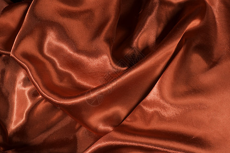 闪亮的红色缎面面料衣服奢华丝绸曲线波浪状纺织品材料布料海浪背景图片