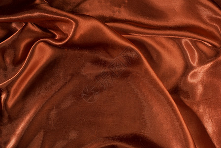 闪亮的红色缎面面料纺织品丝绸材料布料曲线海浪波浪状衣服奢华背景图片