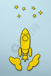 向星星飞去的黄色卡通火箭背景图片