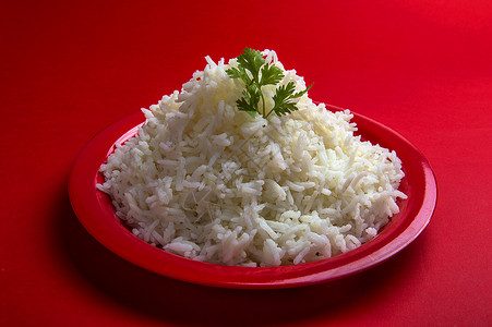 红背景的红色盘子中煮白纯白巴斯马提大米粮食营养文化食物香米烹饪香菜美食纤维饮食背景图片