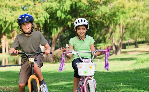 女孩骑着骆驼哥哥和姐姐骑着自行车背景