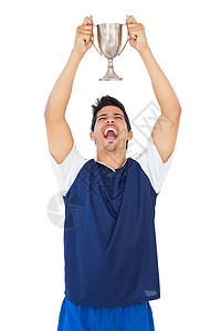 足球运动员举起优胜者杯背景图片
