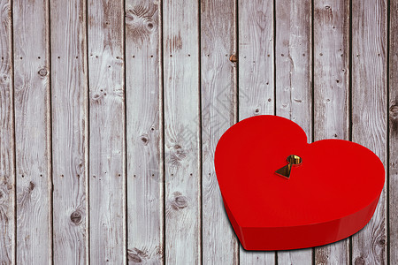 亮红红心形锁红色木头灰色木板锁定情人锁孔背景图片