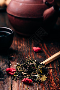 茶壶加茶壶和汤匙的茶碗草莓香草茶勺子红茶饮食叶子浆果水果杯子草本植物味道饮料背景图片